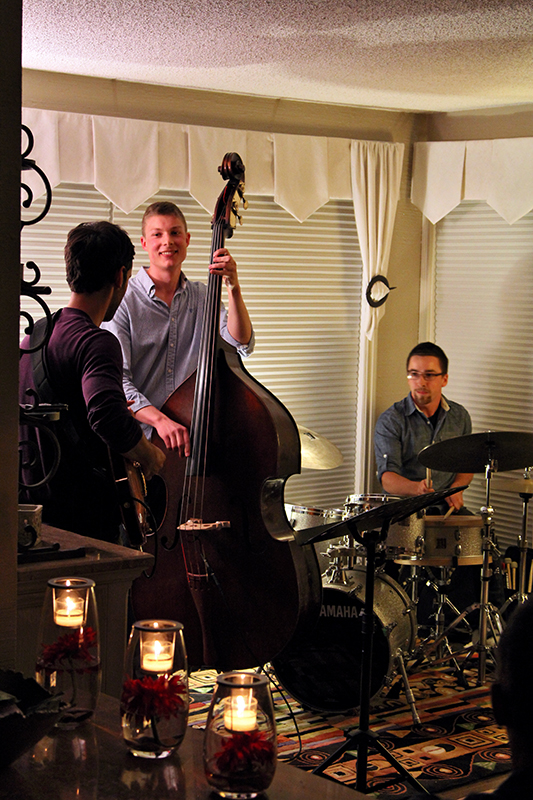The Soren Nissen, Ian Wright and Nate Renner trio. Candles flicker in the foreground as the trio plays on. Photo taken Friday, May 17, 2013.