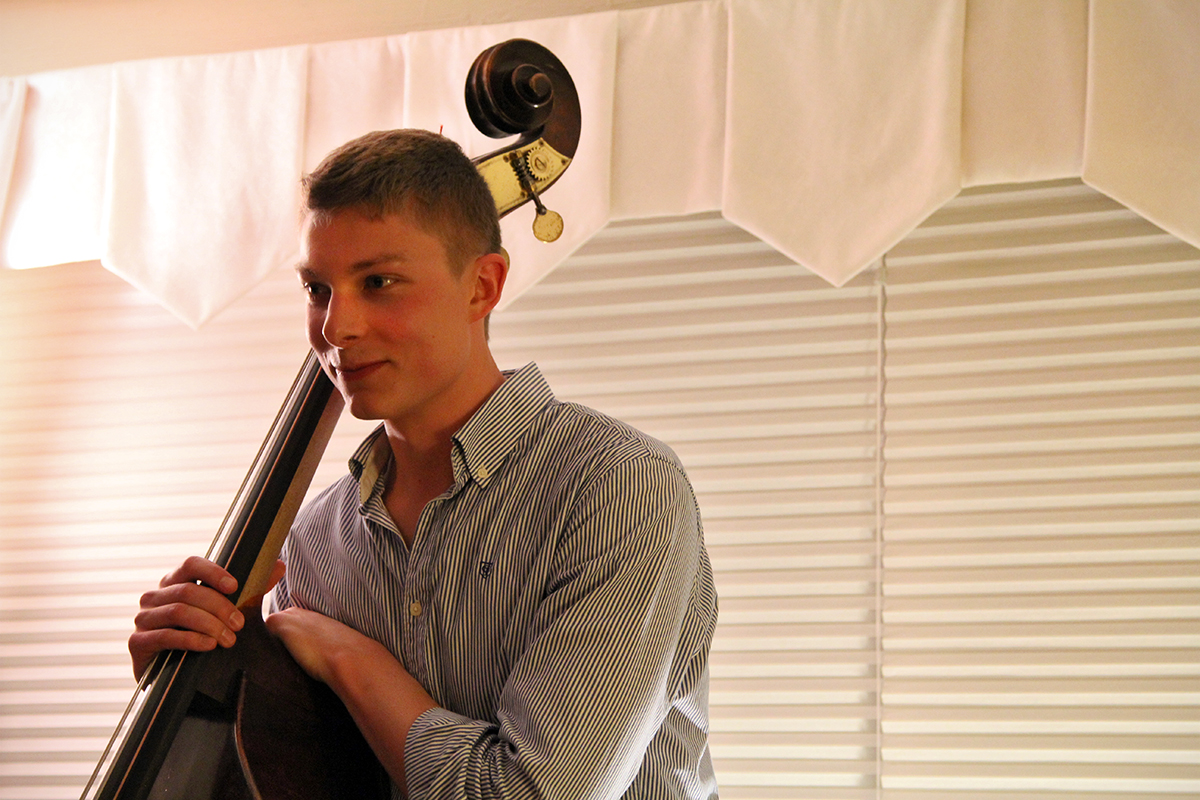 The Soren Nissen, Ian Wright and Nate Renner trio. Nissen leans on his instrument between songs. Photo taken Friday, May 17, 2013.